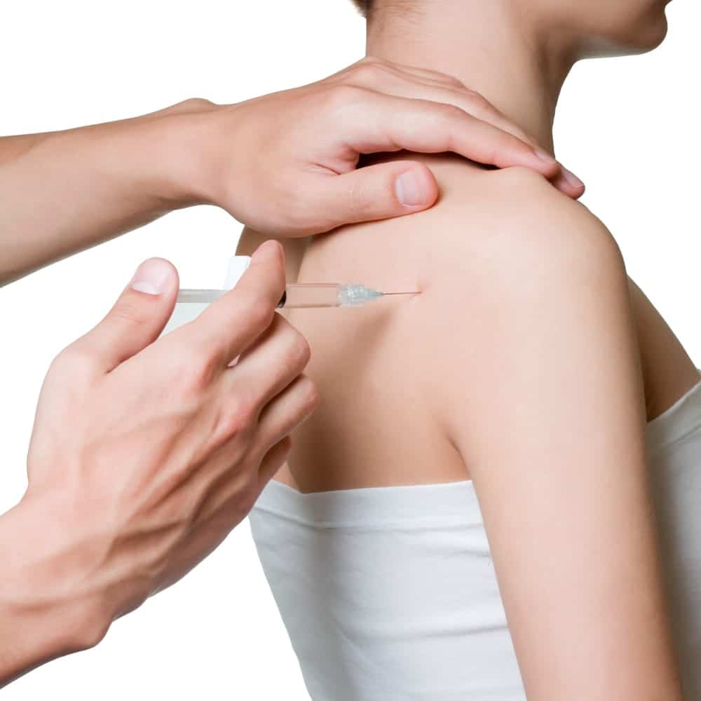 female getting stem cell injections in her shoulder