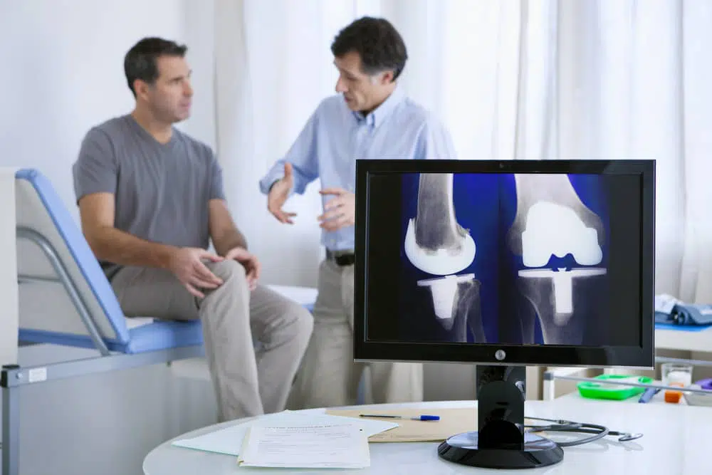 Orthopedic Knee doctor discusses Arthroscopic Knee Surgery To patient.