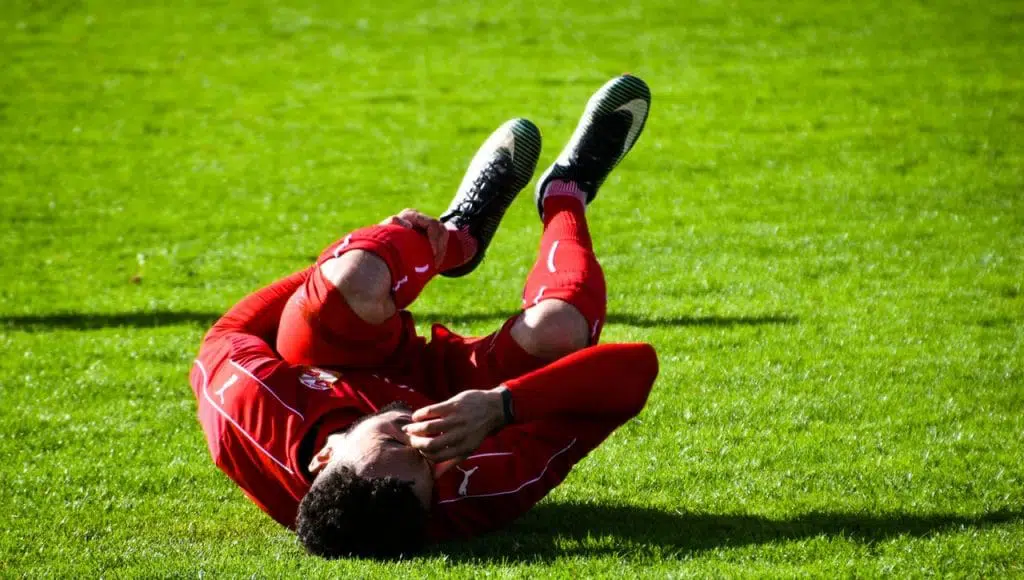 Sports injury in soccer player who is on the field.