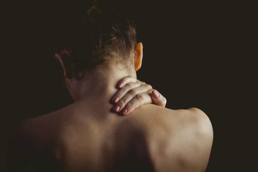 young lady holding her neck due too neck pain
