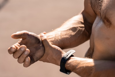 man holding his wrist due to pain