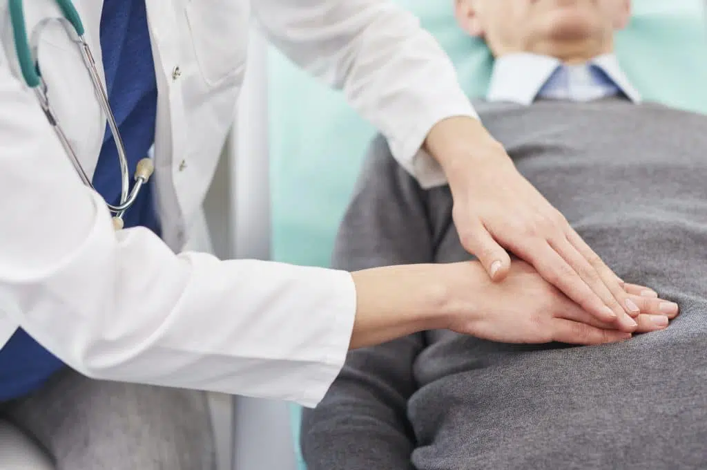 Doctor examining a patients stomach for a hernia