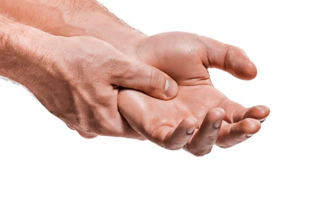photo of a males hands with arthritis pain