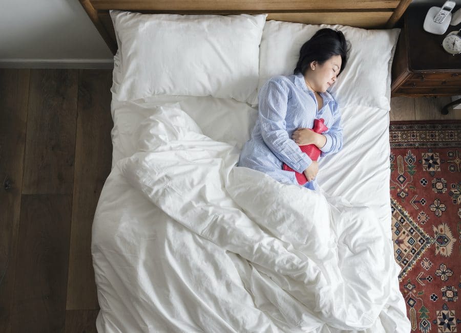 young woman laying in her bed