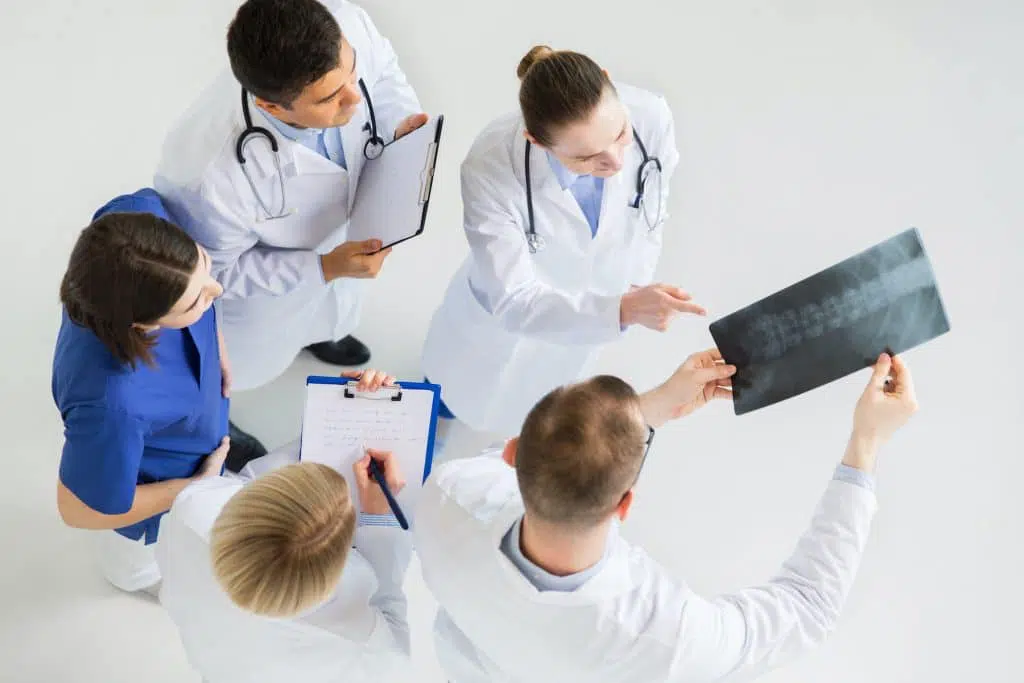 Group of doctors looking at patients records.