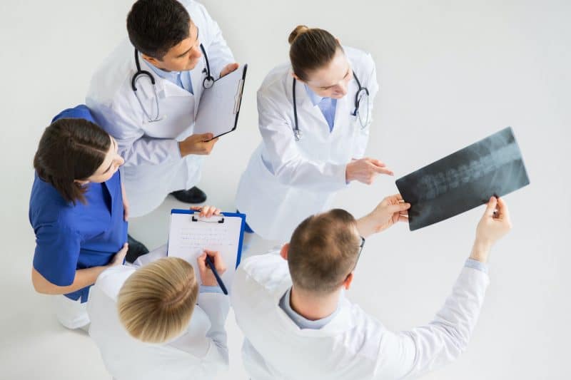 group of doctors looking at patients records