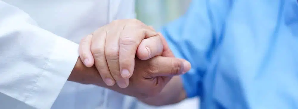 patient and doctor holding hands after regenerative medicine treatment