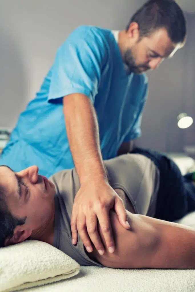 Physical therapist working on a patient's back.