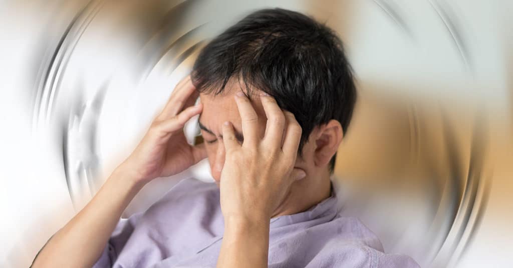 Man having headache and migraine attacks at home.