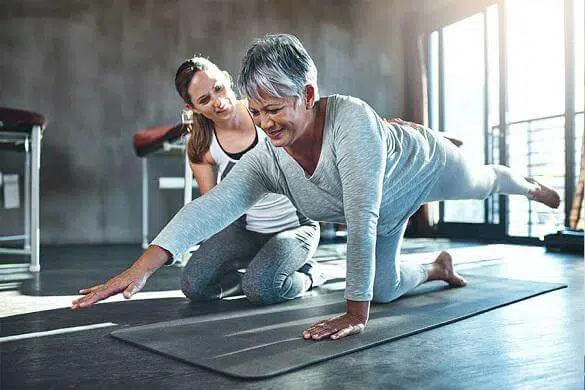 Physical therapist helping a hip bursitis patient