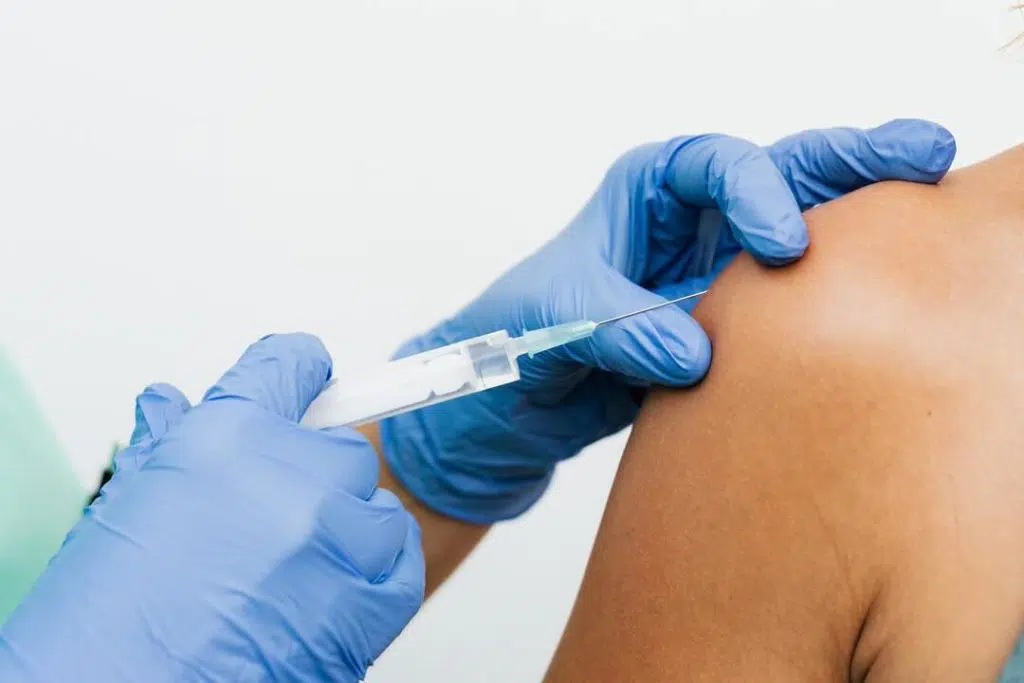 close up of doctor's hand doing trigger point injection on a patient